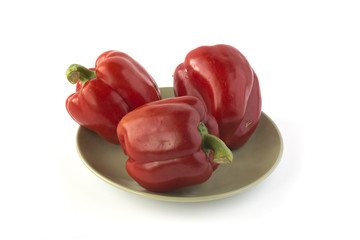 Red peppers on a green ceramic dish