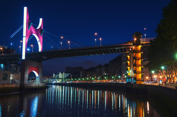 Fototapeta na wymiar Salbeko zubia Bridge over Nevion River in Bilbao, Spain at night