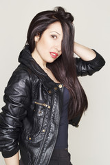 Portrait of beautiful young brunette woman in leather jacket