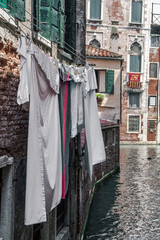 wet clothes hanging on a rope over the water in Venice