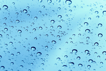 Fototapeta na wymiar Rainy water drop on glass mirror background.