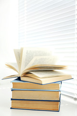 Books on white windowsill, close up