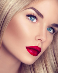 Beautiful blonde girl with healthy blond hair and perfect makeup