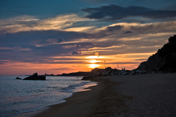 Waves on a sandy beach at sunset, west coast of Sithonia