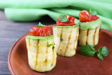Rolled vegetable mallow in brown plate on table, closeup