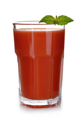 Glass of tomato juice with green leaves isolated on white