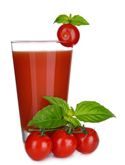 Glass of tomato juice with green leaves isolated on white
