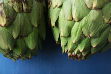 Artichokes on color wooden background