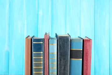 Retro books on turquoise wooden background