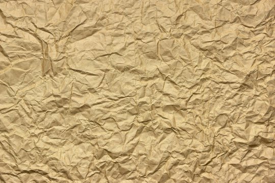 Close-up Of Rough Golden Brown Wrinkled Packaging Paper Texture
