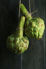 Fototapeta premium Artichokes on color wooden background