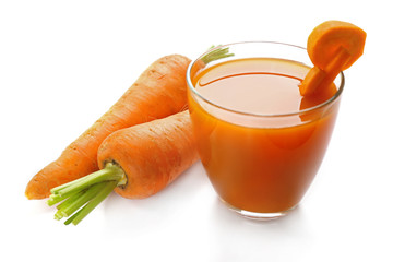 Glass of carrot juice with vegetable slices with vegetables isolated on white