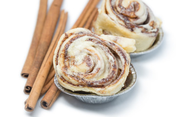 Mini cinnamon rolls with cinnamon stick isolated