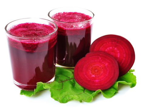 Glasses of beet juice with vegetables isolated on white