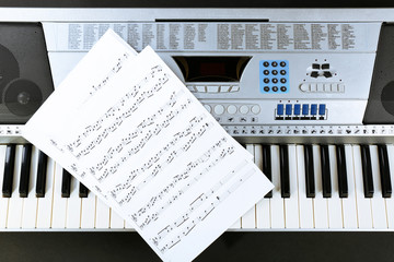 Fototapeta na wymiar Music notes on synthesizer close up