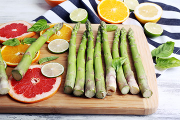Fresh asparagus on wooden cutting board, close-up