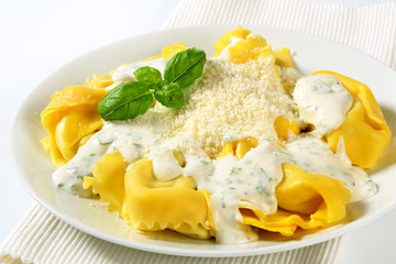 Ricotta and spinach tortelloni with cream sauce and Parmesan
