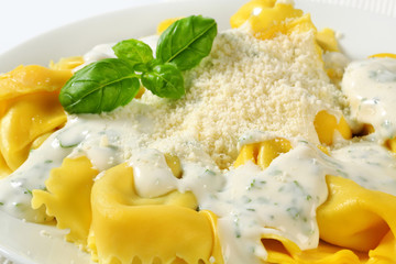 Ricotta and spinach tortelloni with cream sauce and Parmesan