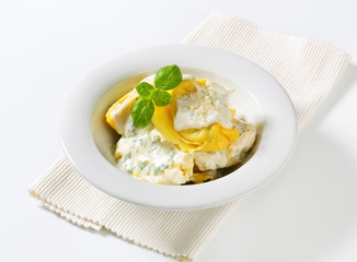 Ricotta and spinach tortelloni with cream sauce and Parmesan