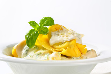 Ricotta and spinach tortelloni with cream sauce and Parmesan