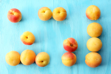 Ripe apricots on wooden table close up
