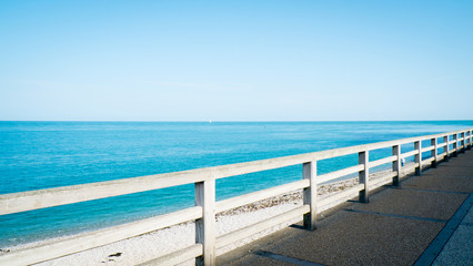 Fototapeta na wymiar Summer view with classic fence beside the beach