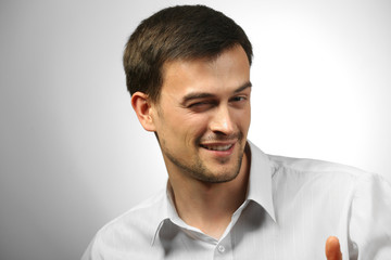 Handsome young man on gray background