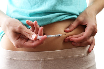 Woman doing shot in stomach close up