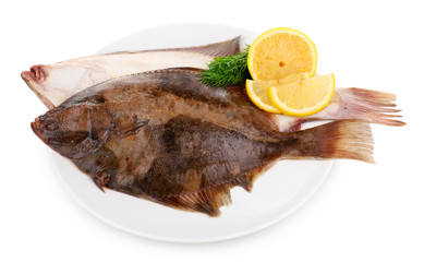 Fresh fishes with lemon on plate isolated on white
