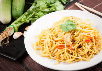 noodles and vegetables on wood