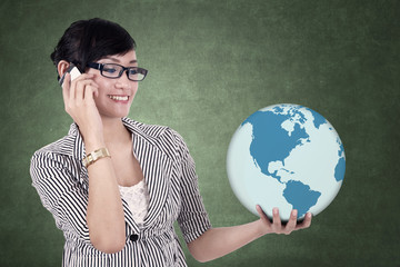 Businesswoman holds a globe