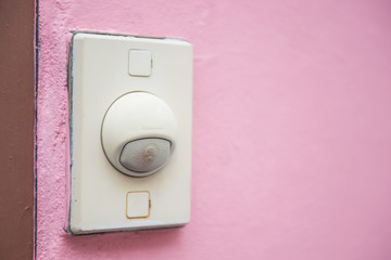old buzzer on pink wall
