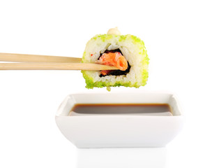 Dipping roll in sauce isolated on white