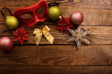 Christmas accessories on dark brown wooden background.