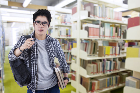 Male arrogant student in the library
