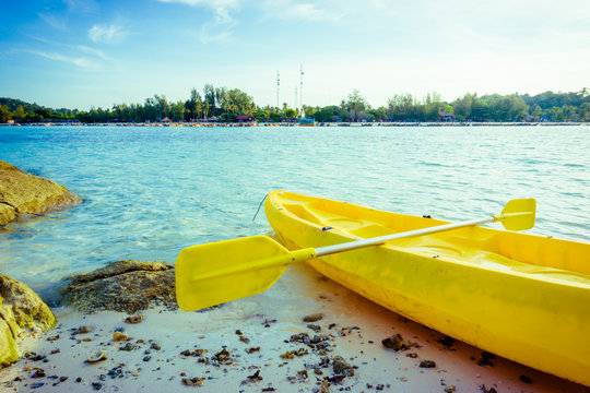 Colorful yellow kayaks on beach in Andaman sea
