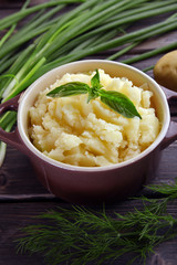 Mashed potatoes in bowl on wooden table, closeup