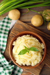 Mashed potatoes in bowl on wooden table, top view