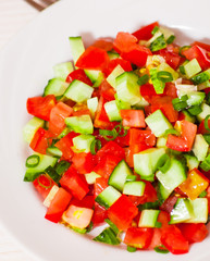 fresh vegetable salad with tomato, cucumber and green onion