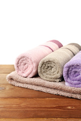 Obraz na płótnie Canvas Rolled bath towels on wooden table, closeup