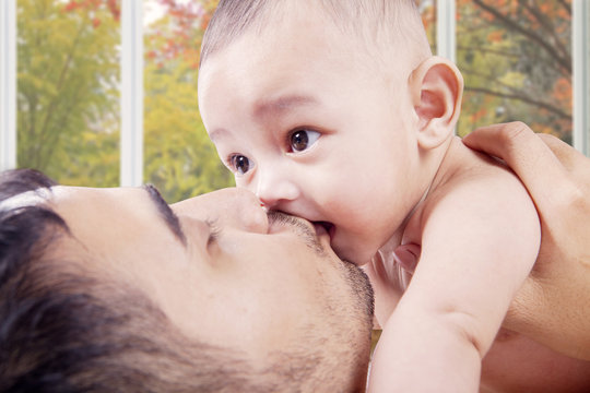 Young Dad Kiss Baby's Mouth