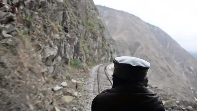 Man and train tracks in fast motion near Alausi, Ecuador