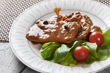 Pork chop with sauce and vegetables