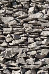 Traditional construction of stone wall without binding material