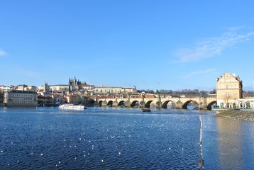 View on the Charles Bridge and Prague Castle on a clear, sunny, winter day. Cityscape.