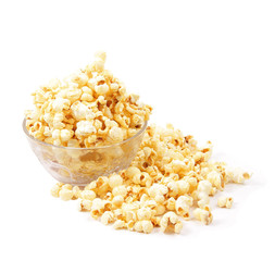Glass bowl with popcorn on white background
