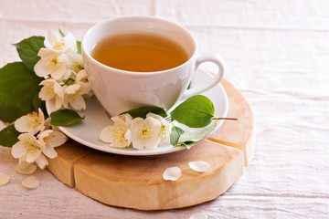 Jasmine tea in a cup with fresh flowers