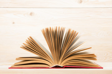 Open book on wooden table. Back to school. Copy space