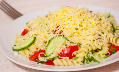 pasta salad with cheese, tomato and cucumber