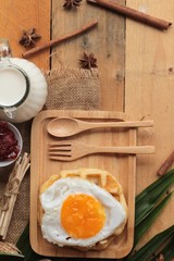 Sweet waffles and fresh milk with jam and egg heart.